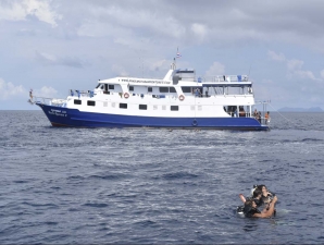 divers waiting for their boat to collect them after their dive and safety stop